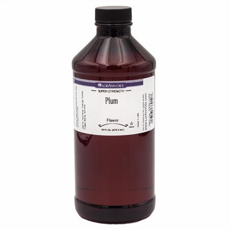 Bottle of plum flavoring with a label on a white background