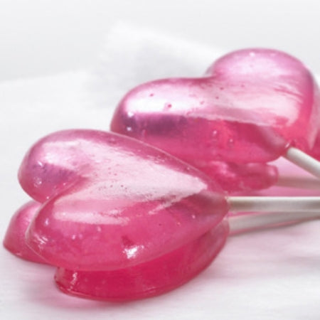 Two pink heart-shaped lollipops on a white background