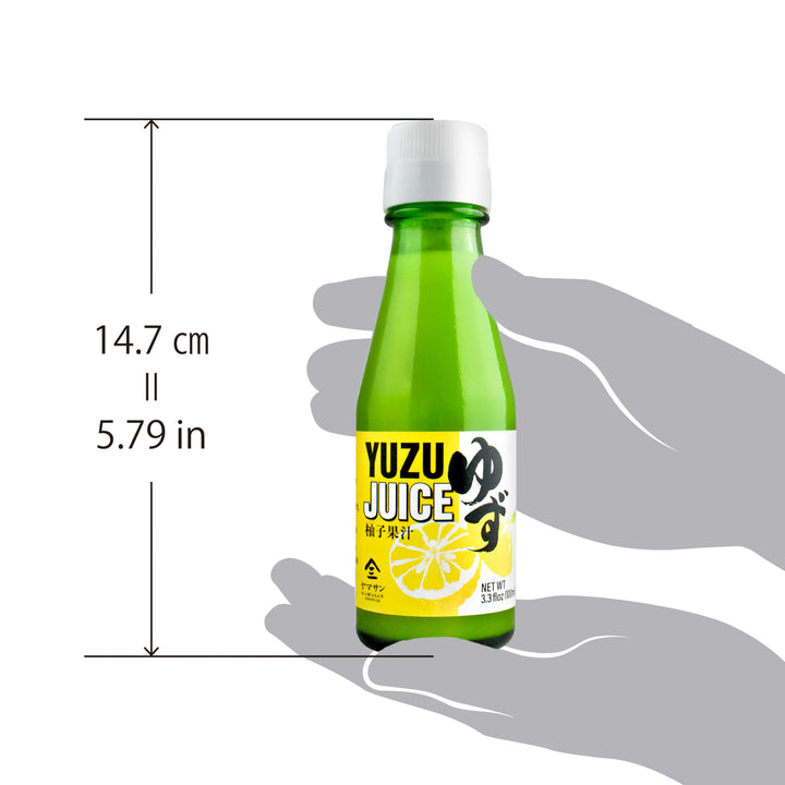 Yuzu juice bottle held in a hand with dimensions indicated