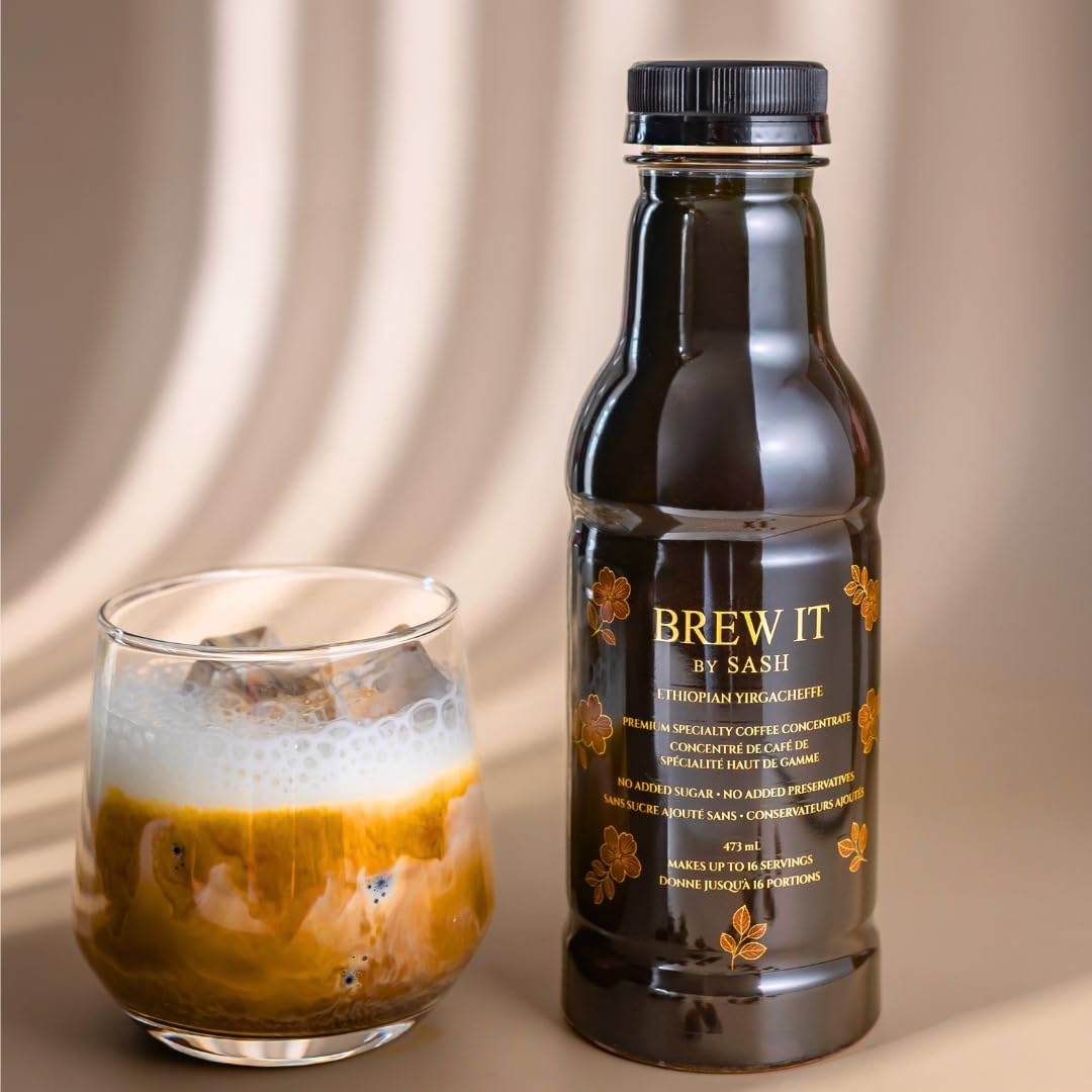 Bottle of 'Brew It by Sash' coffee concentrate next to a glass of coffee on a beige background