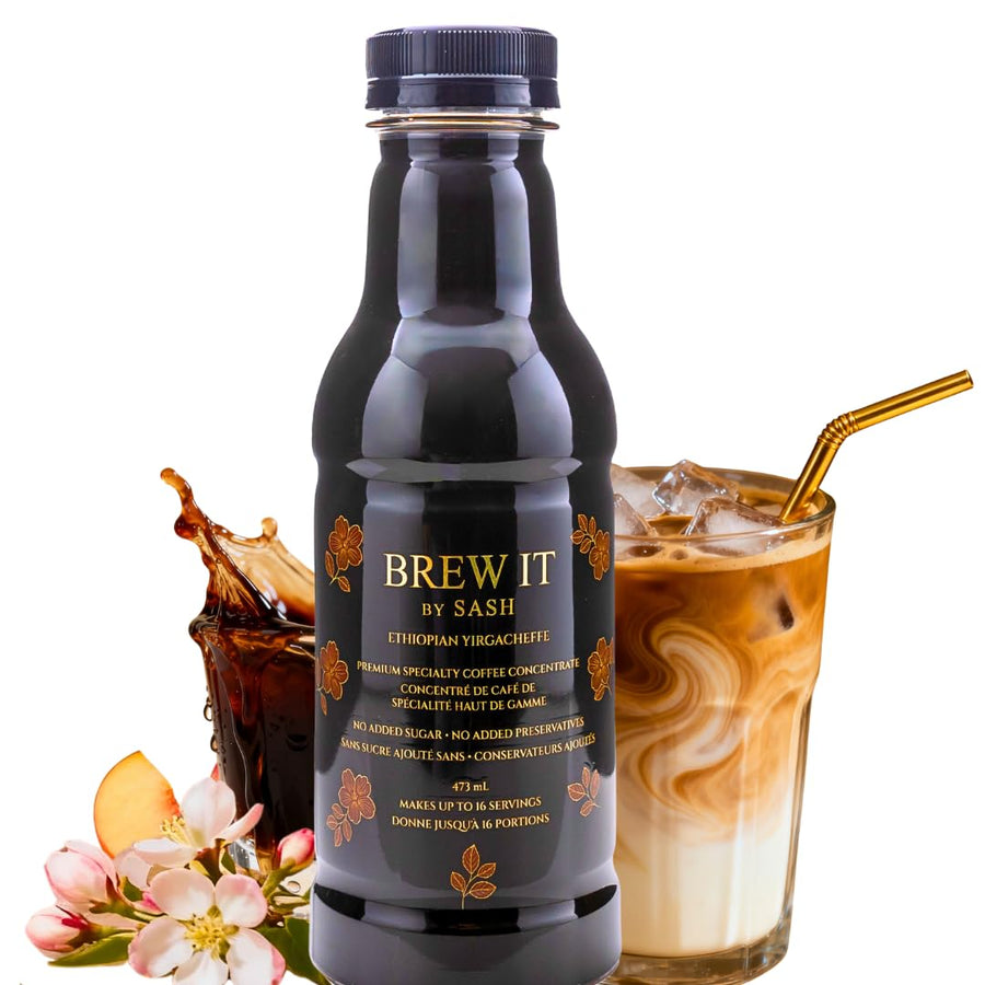Bottle of Brew It by Sash coffee concentrate with iced coffee and flowers on a white background