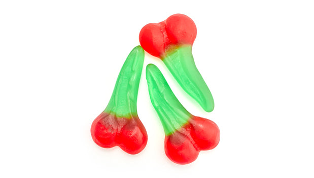 Three red and green gummy cherry candies on a white background