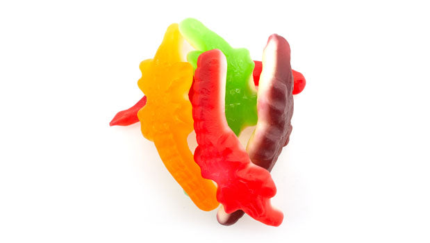 Gummy crocodiles candy on a white background