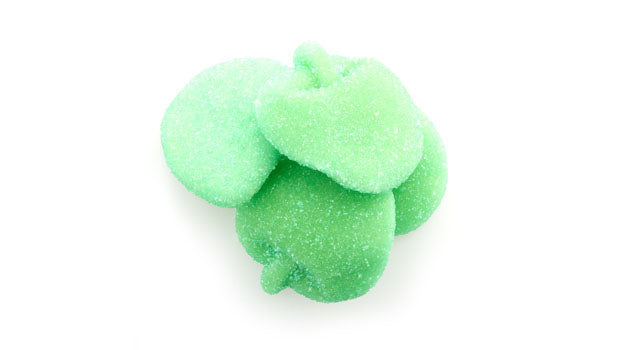 Sour green apple slices gummy candy on a white background