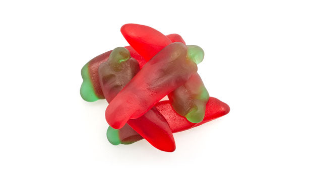 Red and green gummy red peppers candy on a white background