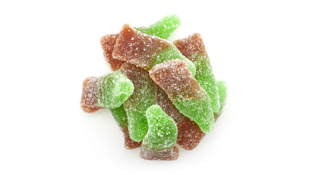 Intense gummy cola bottles candy on a white background
