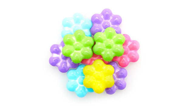 Blooming flowers pressed candy on a white background