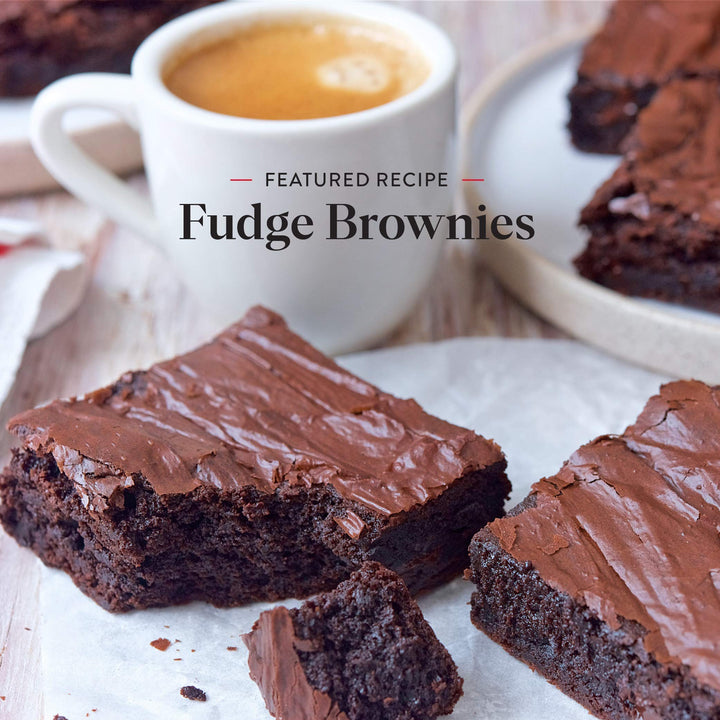 Fudge brownies with a cup of coffee on a wooden surface