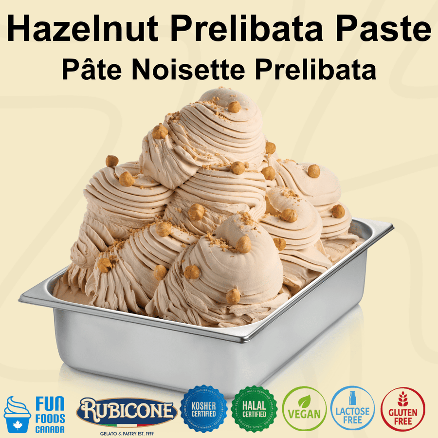 A wide metal gelato pan filled with hazelnut-prelibata ice cream, topped with swirls of the same cream and small hazelnut pieces, on a pale beige background with large text reading 'Hazelnut Prelibata Paste' and certification logos along the bottom.