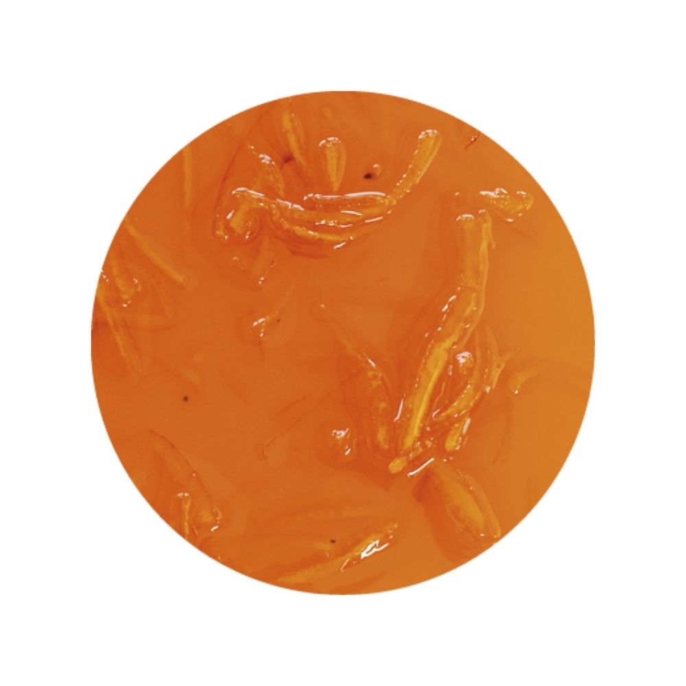 Texture image of orange sundae dessert topping on a white background - orange dessert sauce with candied orange peels