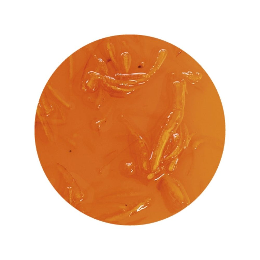 Texture image of orange sundae dessert topping on a white background - orange dessert sauce with candied orange peels
