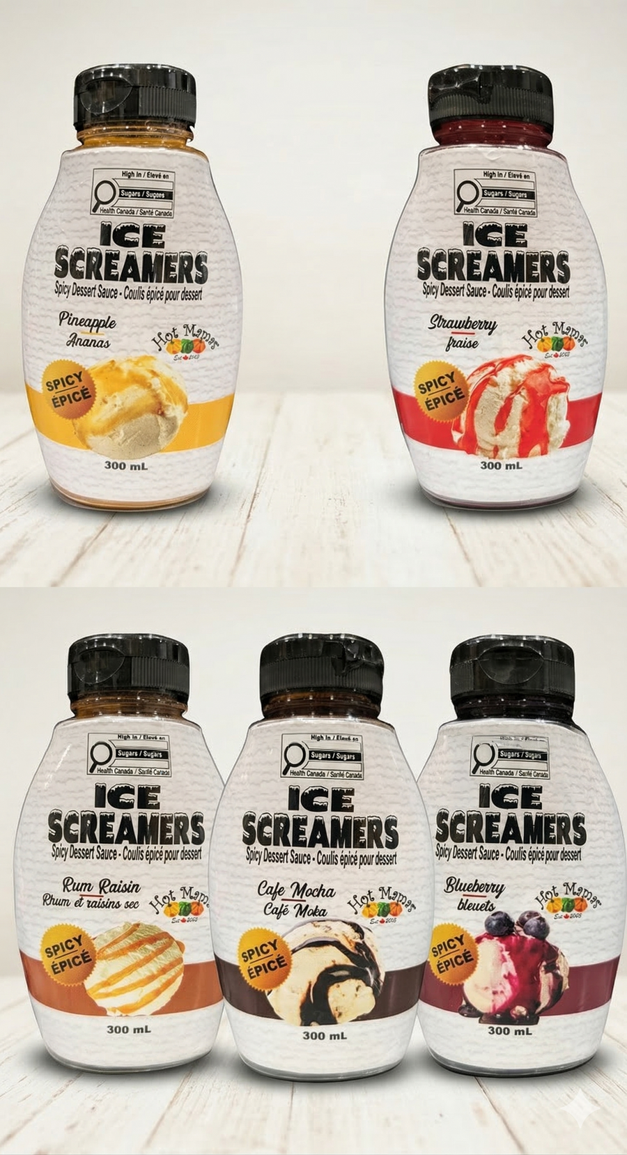 Five bottles of Ice Screamers ice cream syrups on a wooden surface.