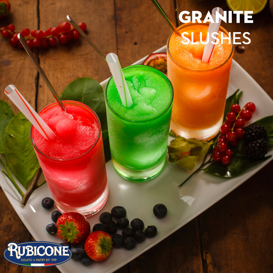 Three colorful slushes in glasses made with Rubicone Neutral Slushie Base with straws on a white tray, surrounded by berries and leaves, with Rubicone branding.