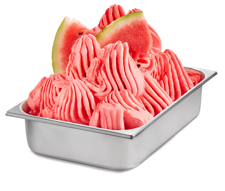 Watermelon Gelato in a wide stainless steel pan with watermelon wedges - Made with Rubicone Watermelon Ready Base