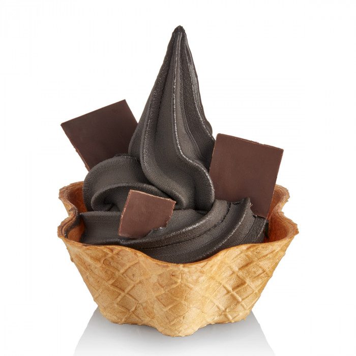 Chocolate ice cream in a waffle cup with chocolate pieces on a white background