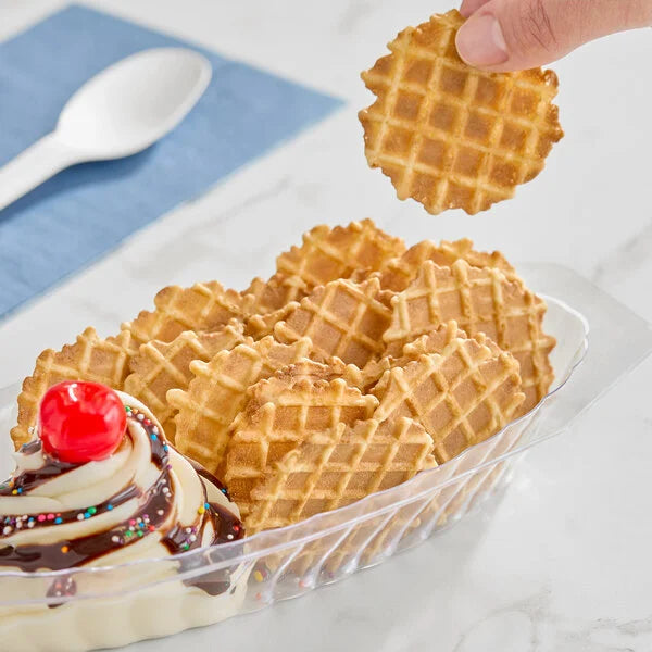 Waffle cone chips nachos with a cherry on top and a hand picking up a waffle cone.